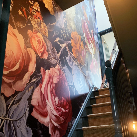 Floral mural on stairwell wall.