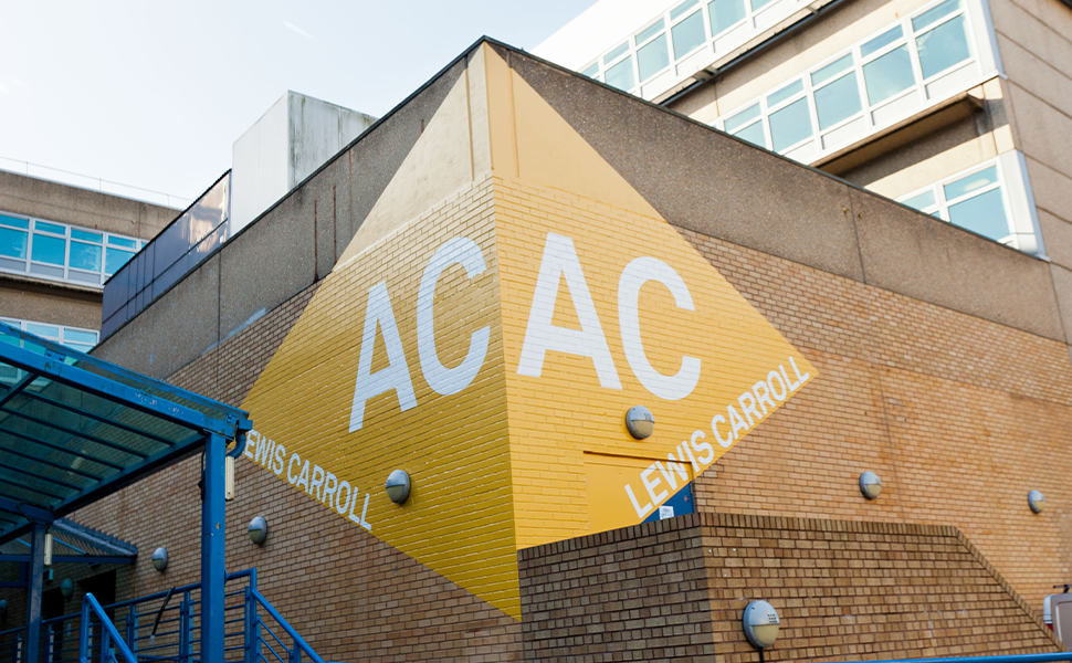 University of Surrey Wayfinding installed on brick wall